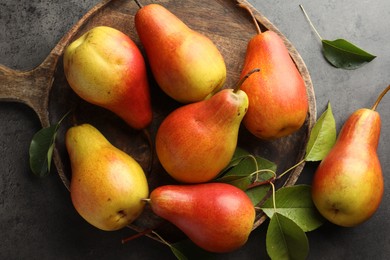 Photo of Ripe juicy pears on grey table, flat lay