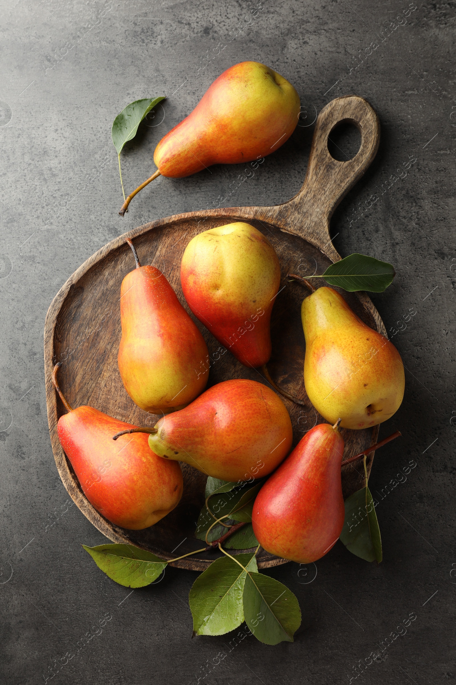 Photo of Ripe juicy pears on grey table, flat lay