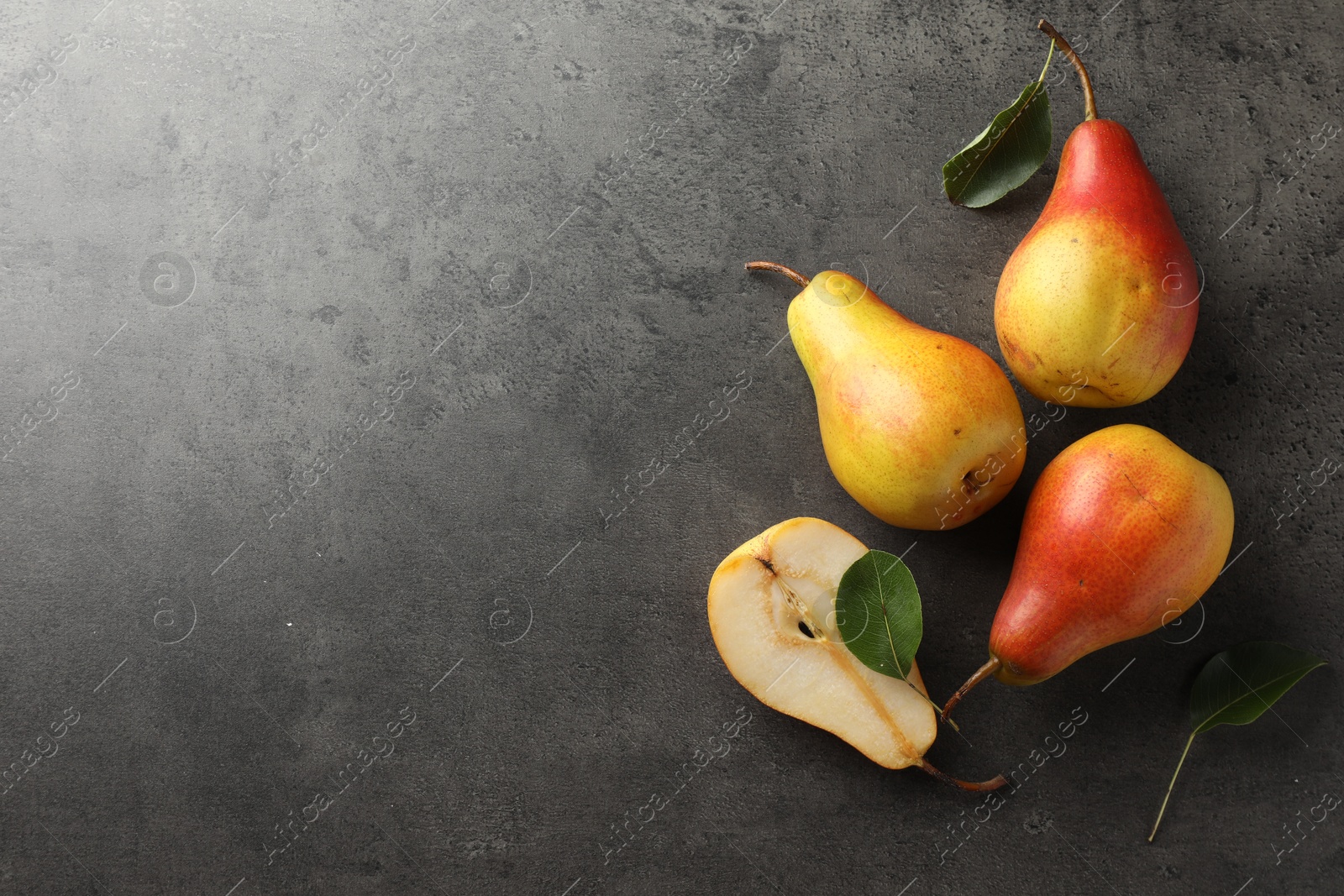 Photo of Ripe juicy pears on grey table, flat lay. Space for text