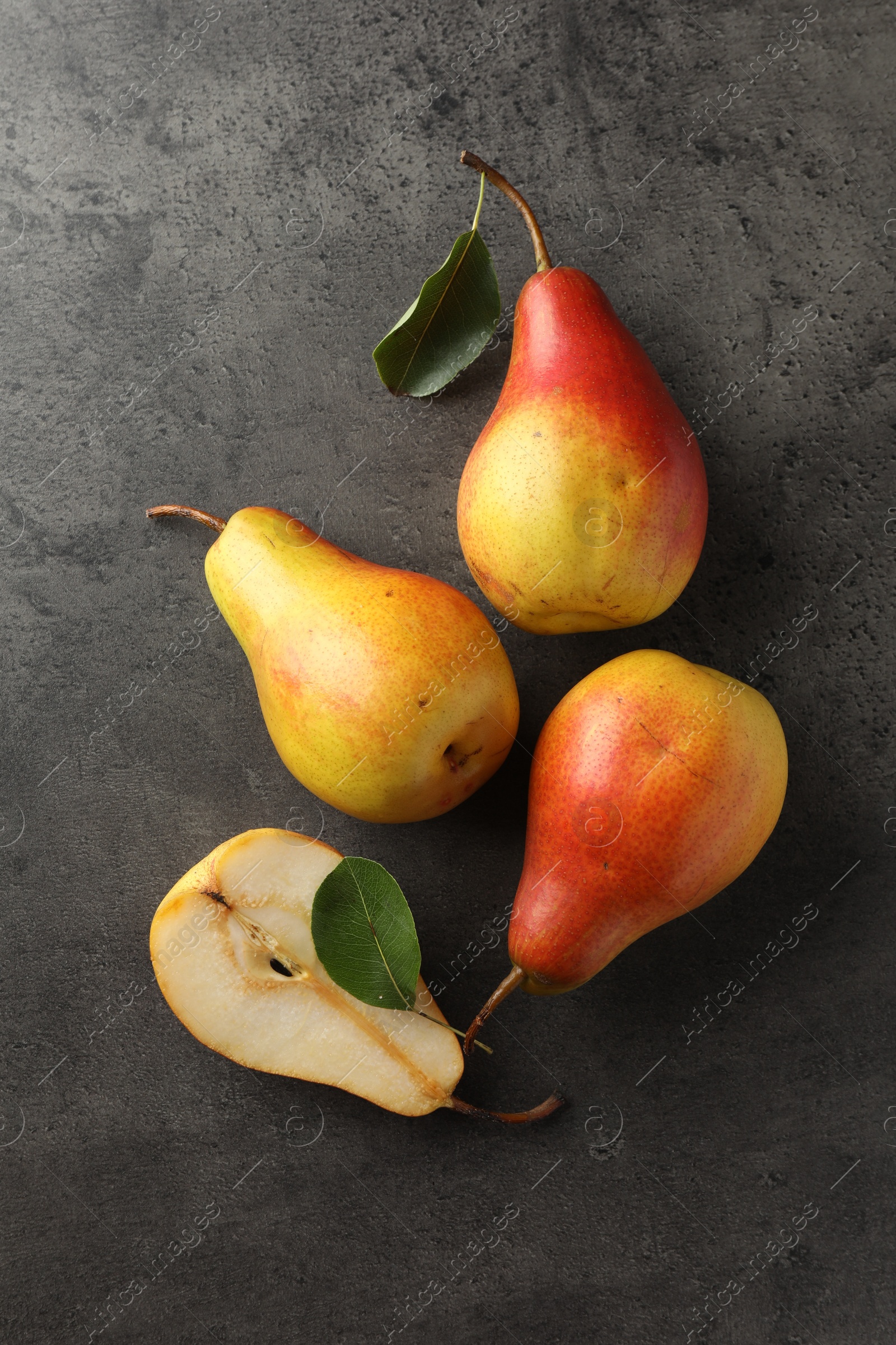 Photo of Ripe juicy pears on grey table, flat lay