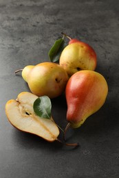 Photo of Ripe juicy pears on grey table, closeup