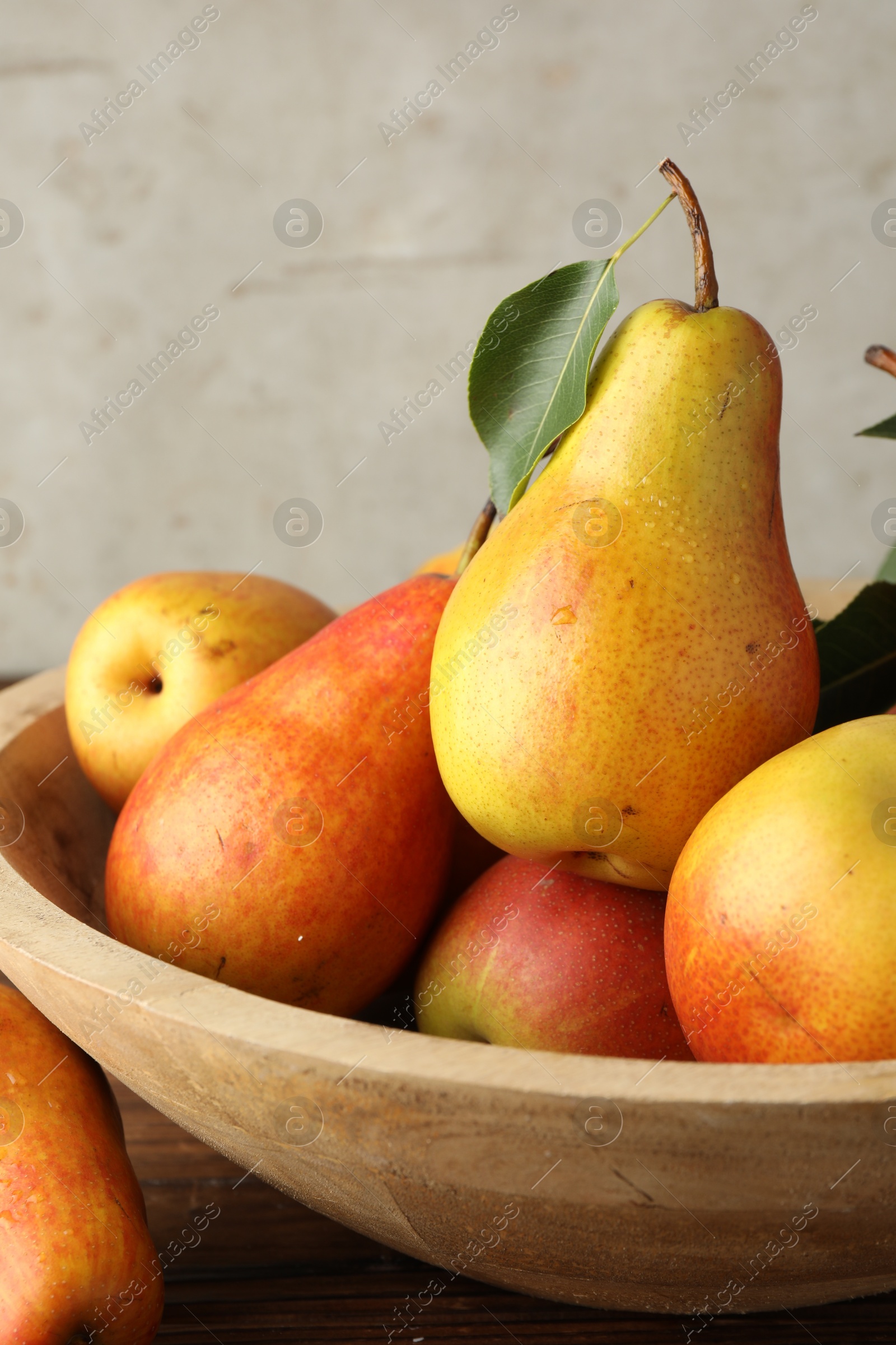 Photo of Ripe juicy pears on wooden table, closeup