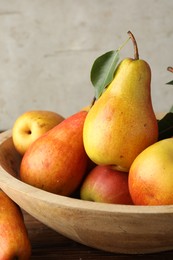 Photo of Ripe juicy pears on wooden table, closeup