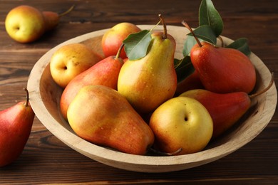 Photo of Ripe juicy pears on wooden table, closeup