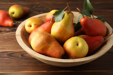 Photo of Ripe juicy pears on wooden table, closeup