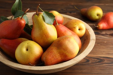 Photo of Ripe juicy pears on wooden table, closeup