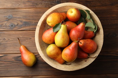 Photo of Ripe juicy pears on wooden table, top view