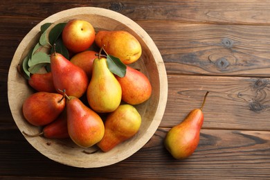 Photo of Ripe juicy pears on wooden table, top view