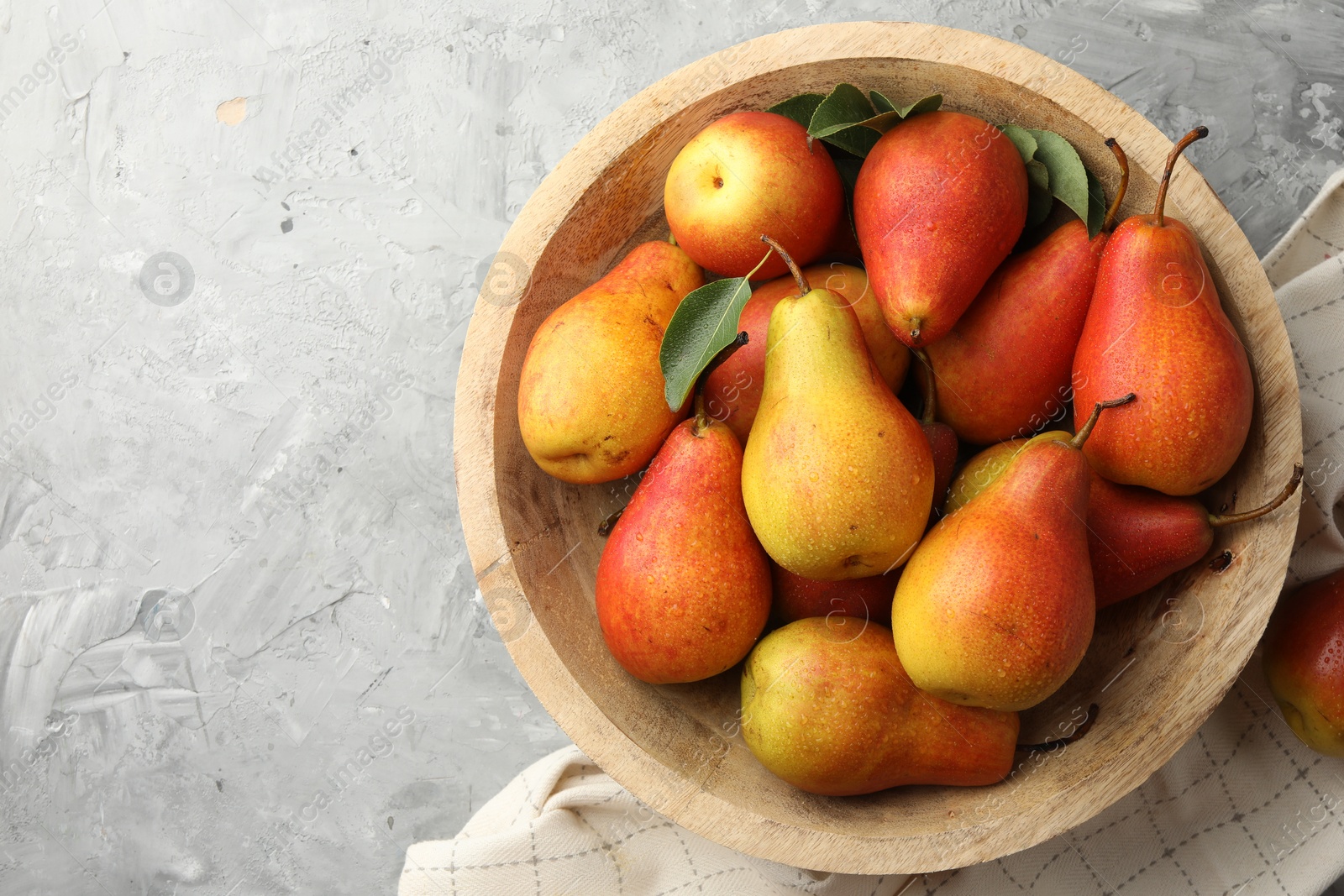 Photo of Ripe juicy pears on grey table, top view