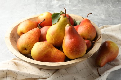 Photo of Ripe juicy pears on grey table, closeup