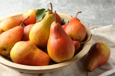 Photo of Ripe juicy pears on grey table, closeup