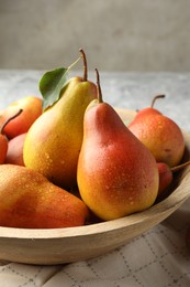 Photo of Ripe juicy pears in bowl on table, closeup