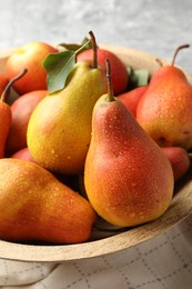 Photo of Ripe juicy pears in bowl on table, closeup