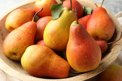 Photo of Ripe juicy pears in bowl on table, closeup