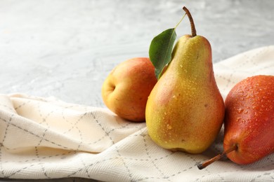 Photo of Ripe juicy pears on grey table, closeup. Space for text