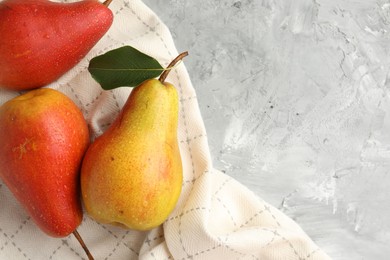 Photo of Ripe juicy pears on grey table, flat lay. Space for text