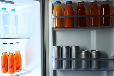 Photo of Many different cold drinks in refrigerator, closeup