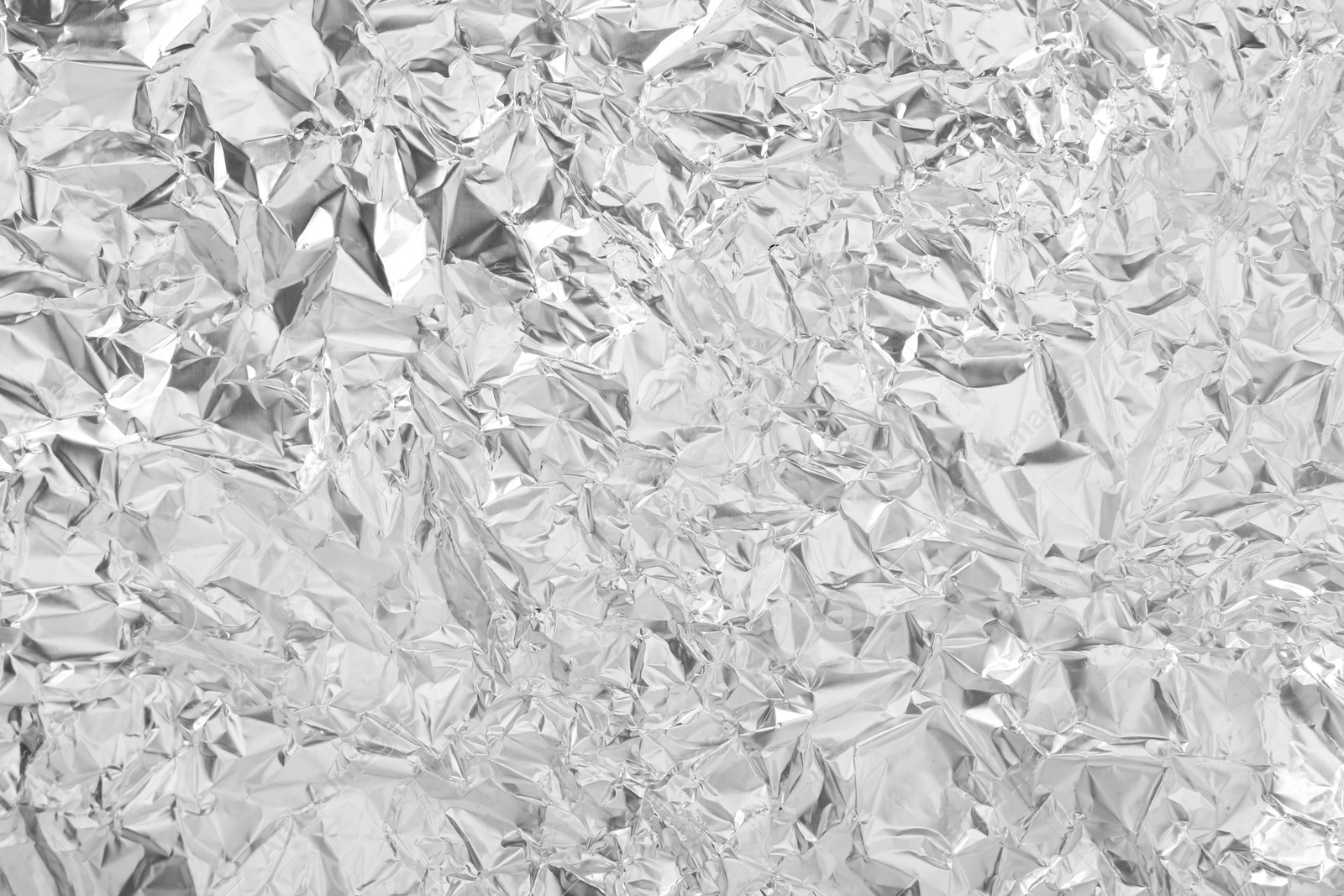 Photo of Shiny silver tinfoil surface as background, top view