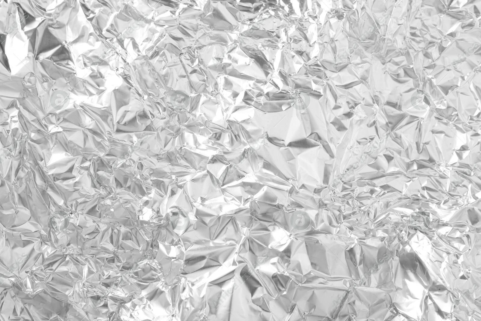 Photo of Shiny silver tinfoil surface as background, top view