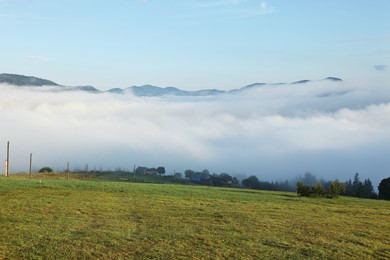 Photo of Beautiful mountains covered with fog in morning