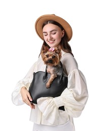 Beautiful young woman holding bag with cute Yorkshire Terrier dog isolated on white