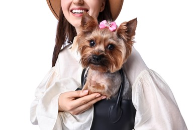 Young woman holding bag with cute Yorkshire Terrier dog isolated on white, closeup