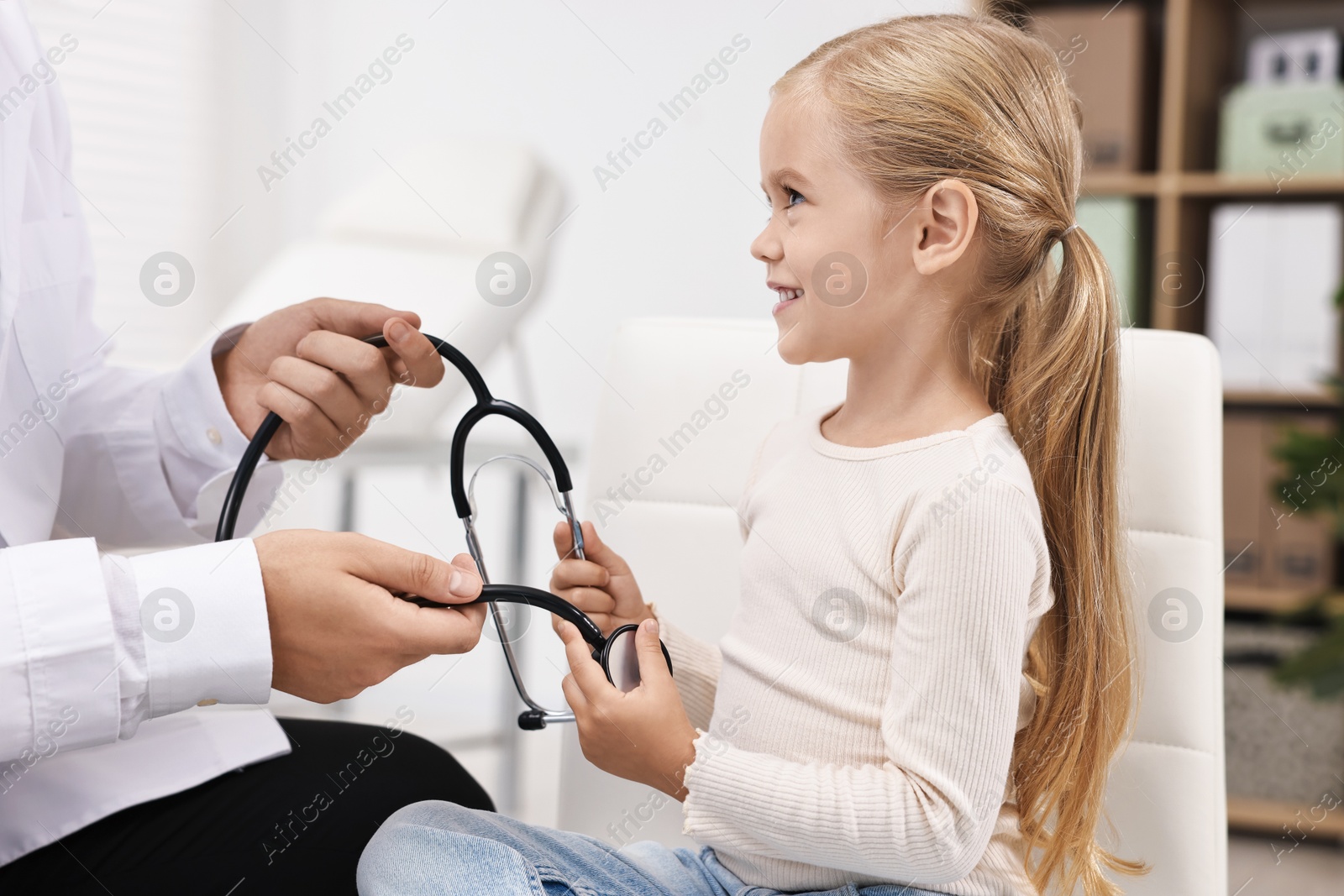 Photo of Little girl having appointment with doctor in hospital