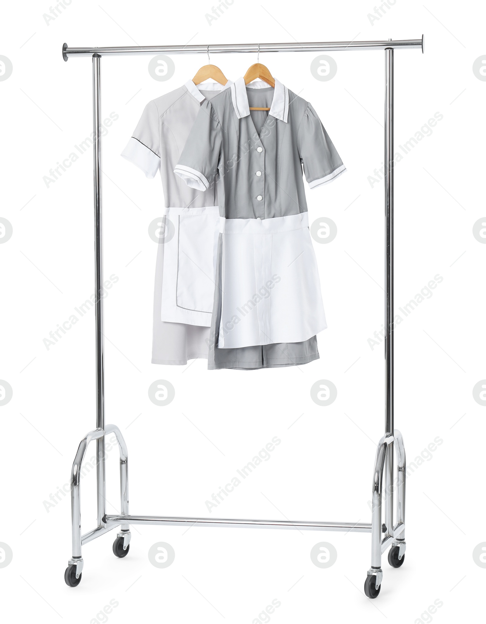 Photo of Maids' uniforms on clothing rack isolated on white