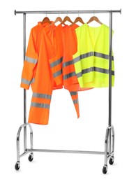 Photo of Workers' uniforms on clothing rack isolated on white