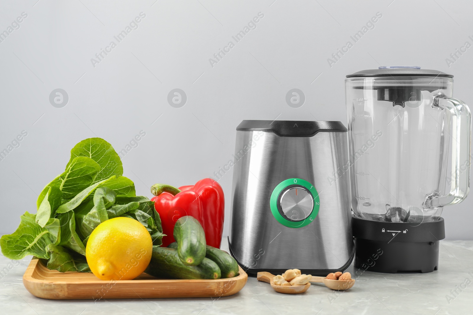 Photo of Blender and healthy products on grey marble table