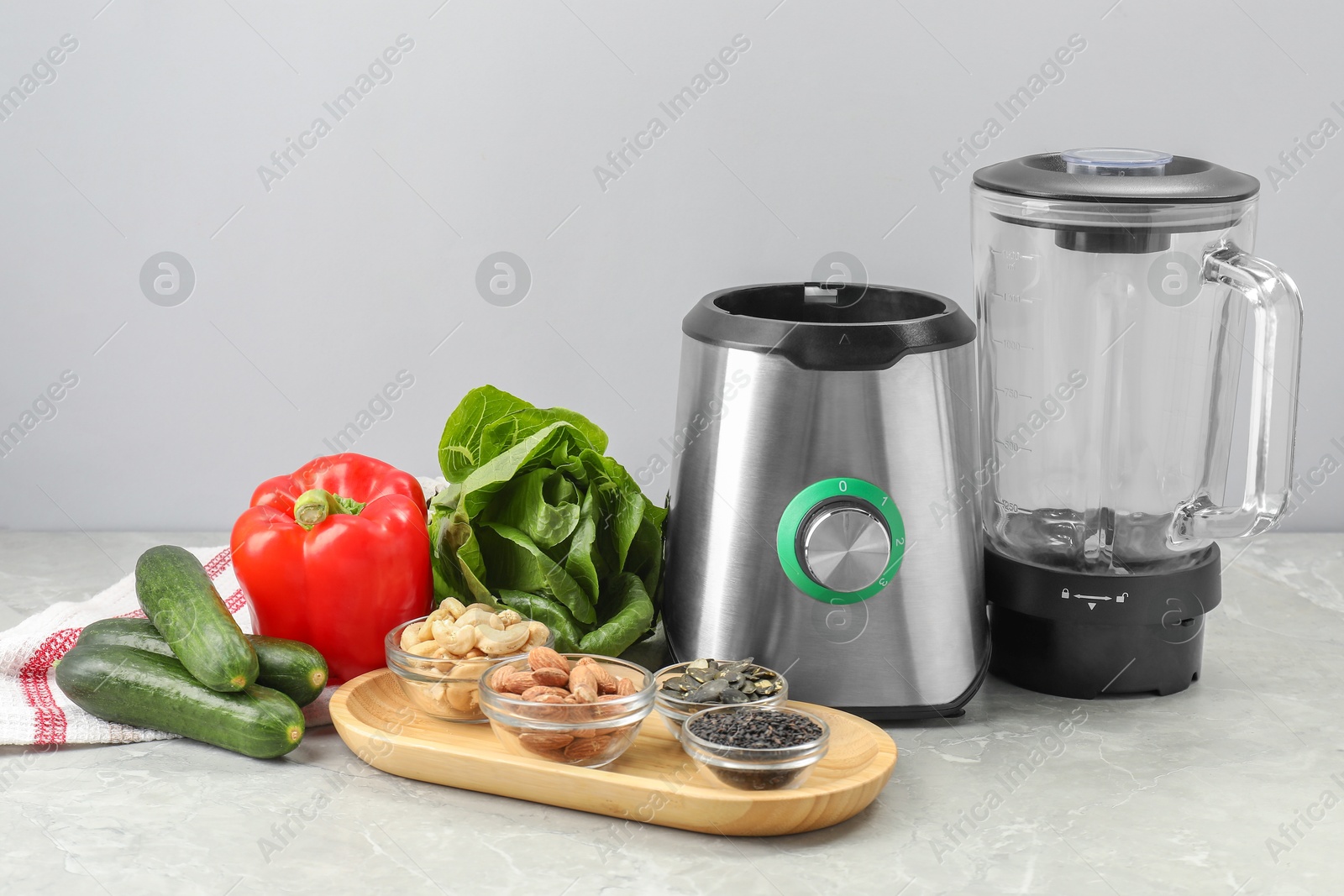 Photo of Blender and healthy products on grey marble table