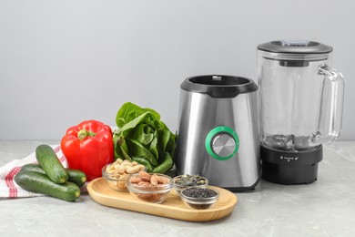 Photo of Blender and healthy products on grey marble table