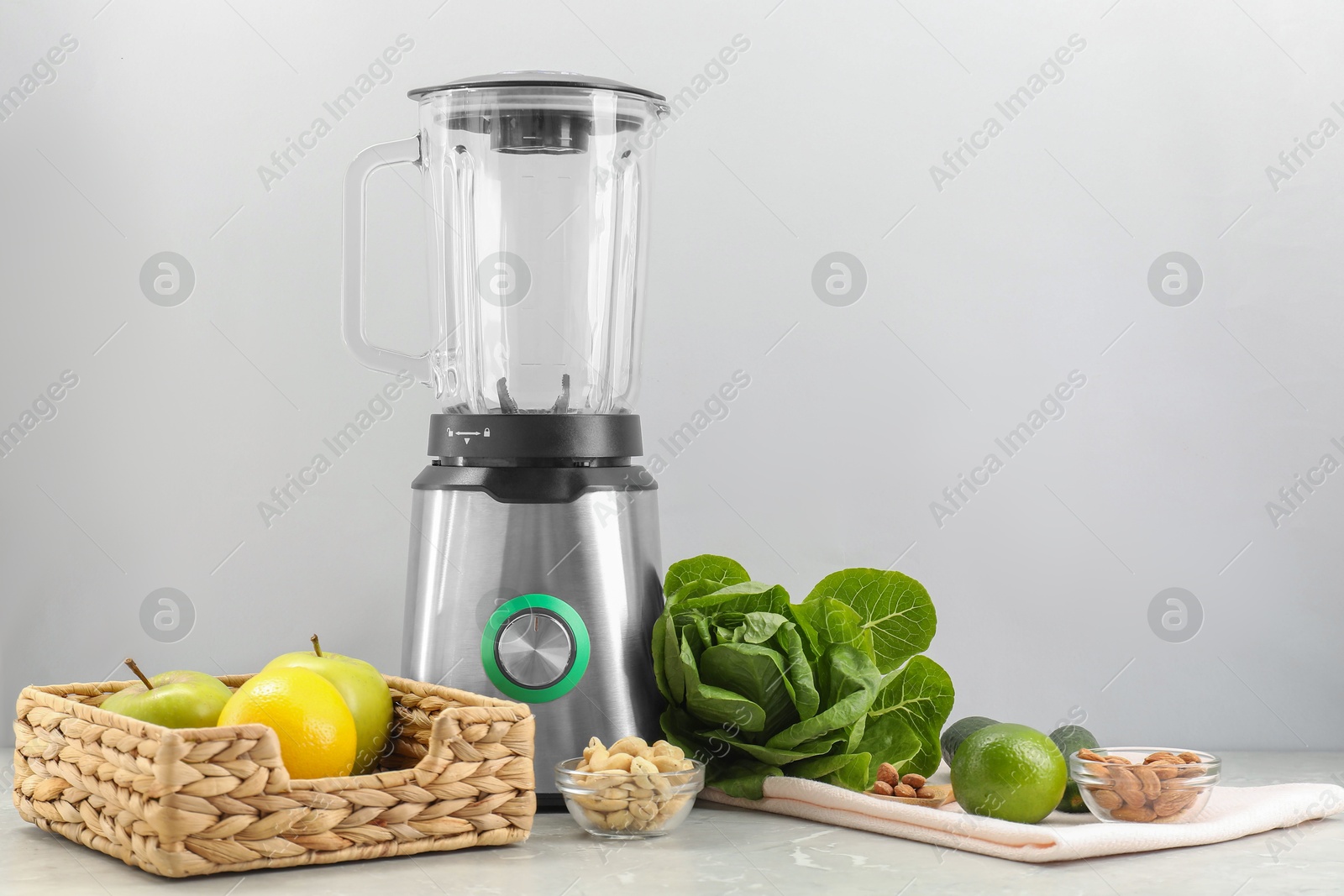 Photo of Blender and healthy products on grey marble table