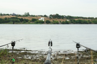 Photo of Fishing rods and bite alarms near lake at summer