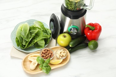 Photo of Modern blender with ingredients for smoothie on white marble table in kitchen