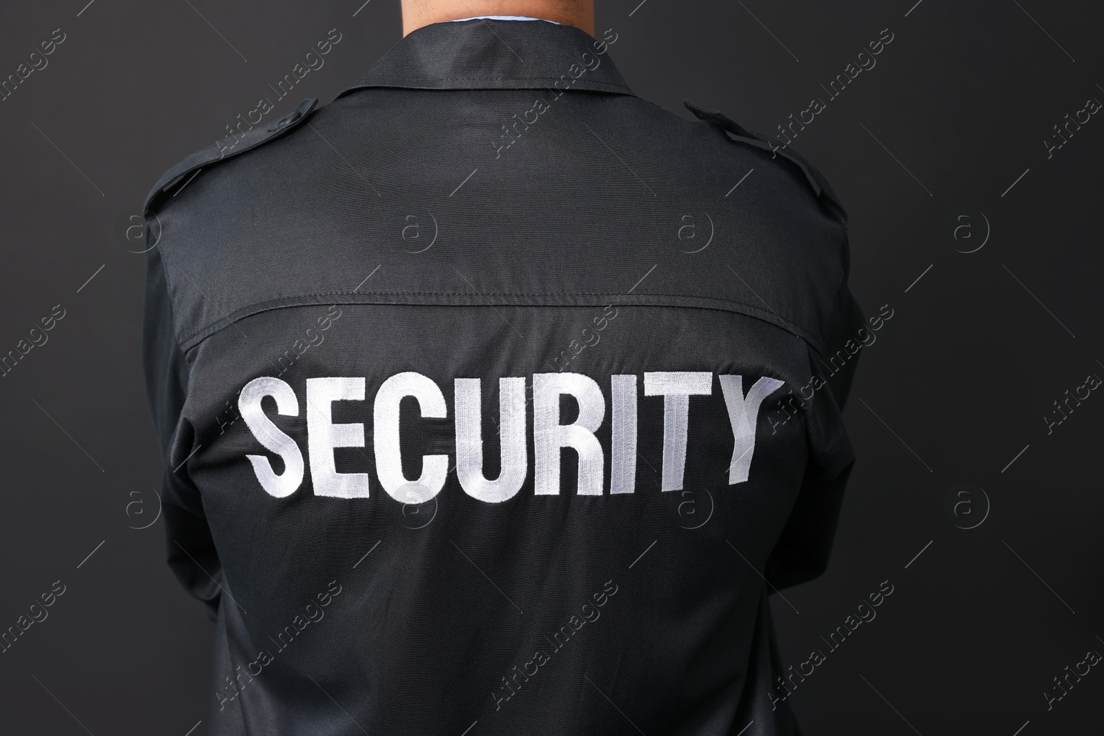 Photo of Security guard in uniform on black background, closeup