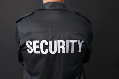 Photo of Security guard in uniform on black background, closeup