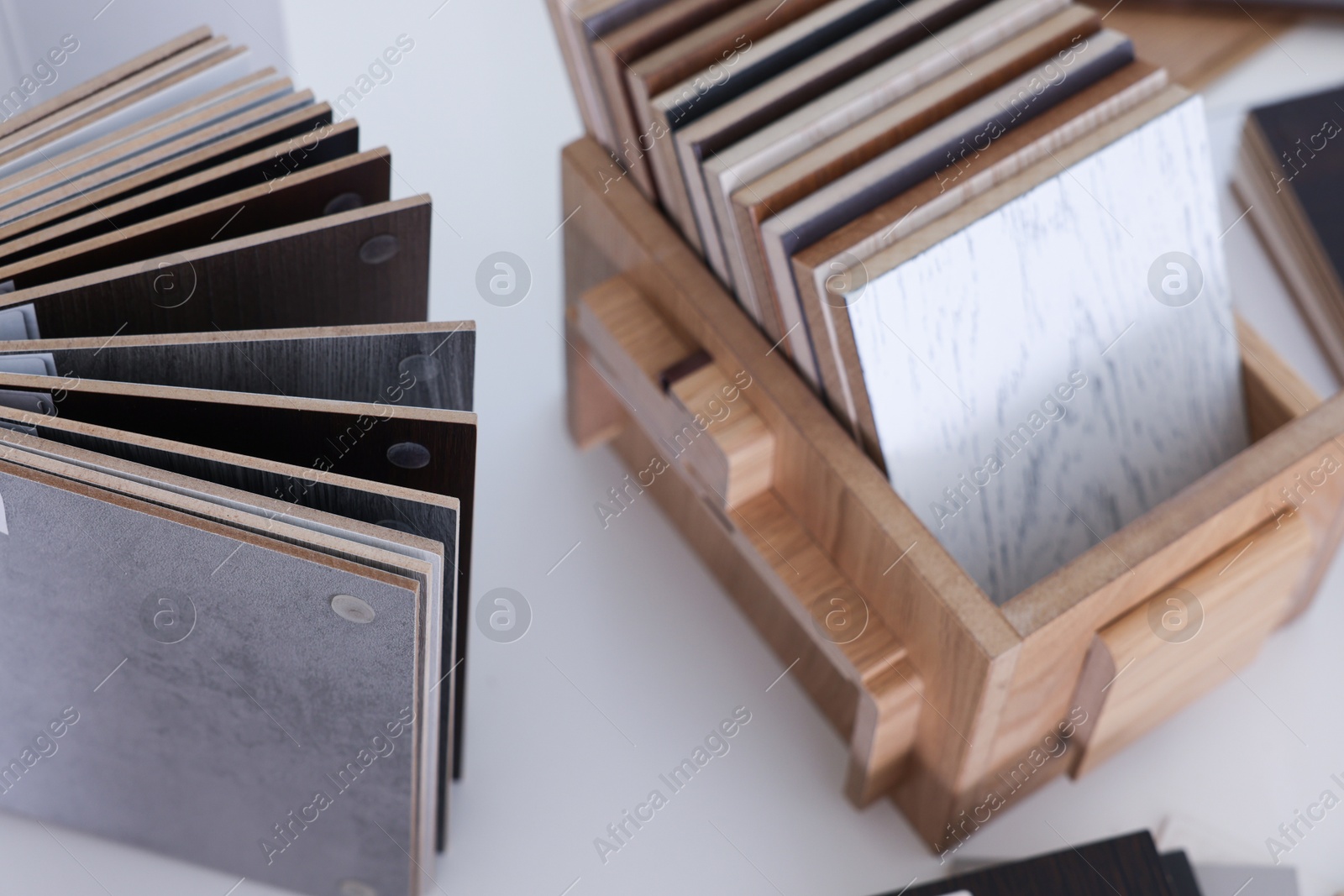 Photo of Different samples of wooden flooring on white table