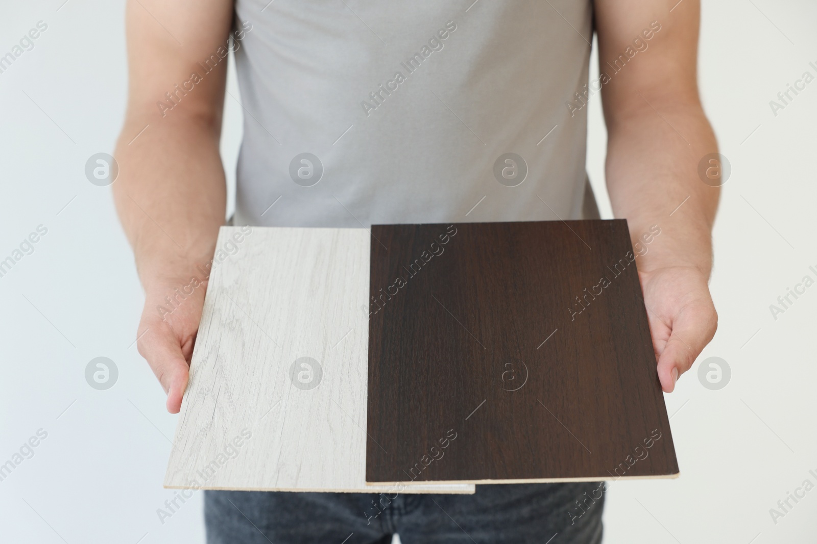 Photo of Man with samples of wooden flooring indoors, closeup