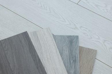 Photo of Different samples of wooden flooring indoors, top view