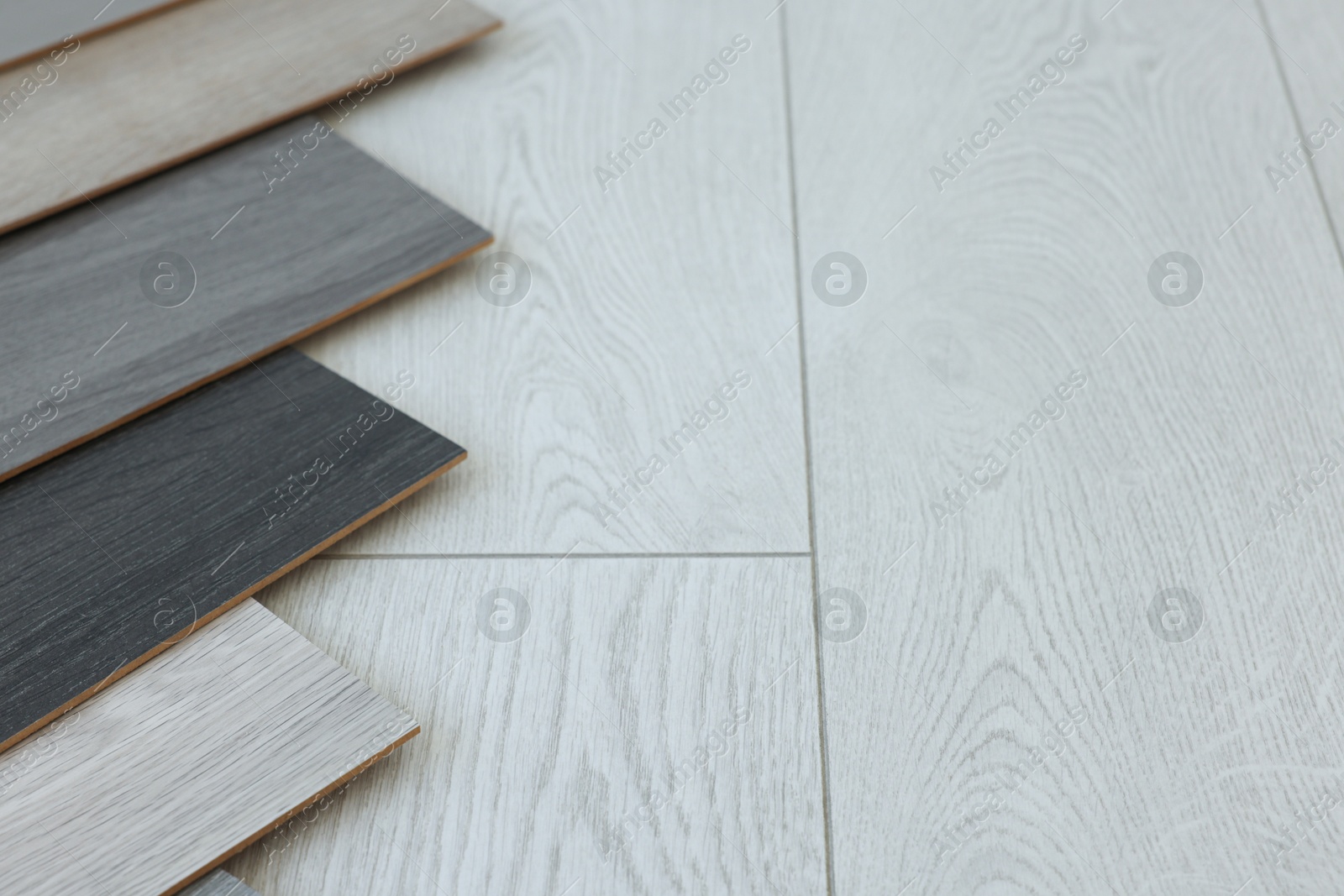 Photo of Different samples of wooden flooring indoors, space for text