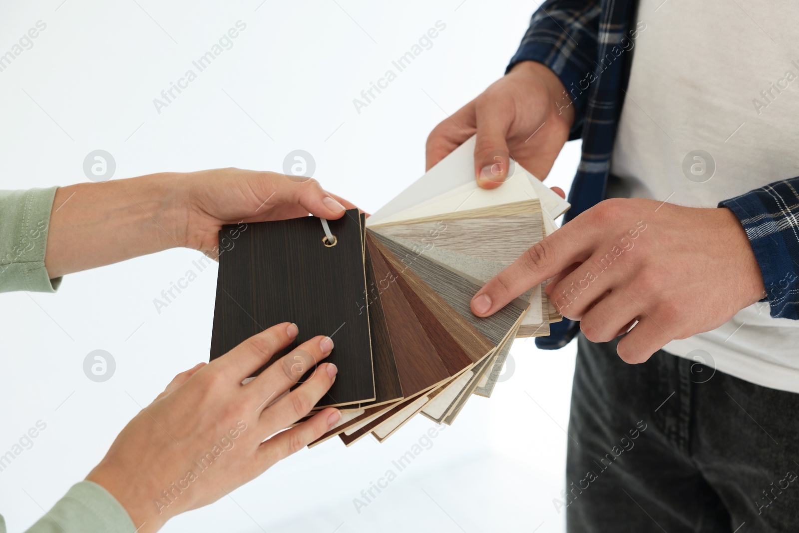 Photo of People choosing samples of wooden flooring indoors, closeup