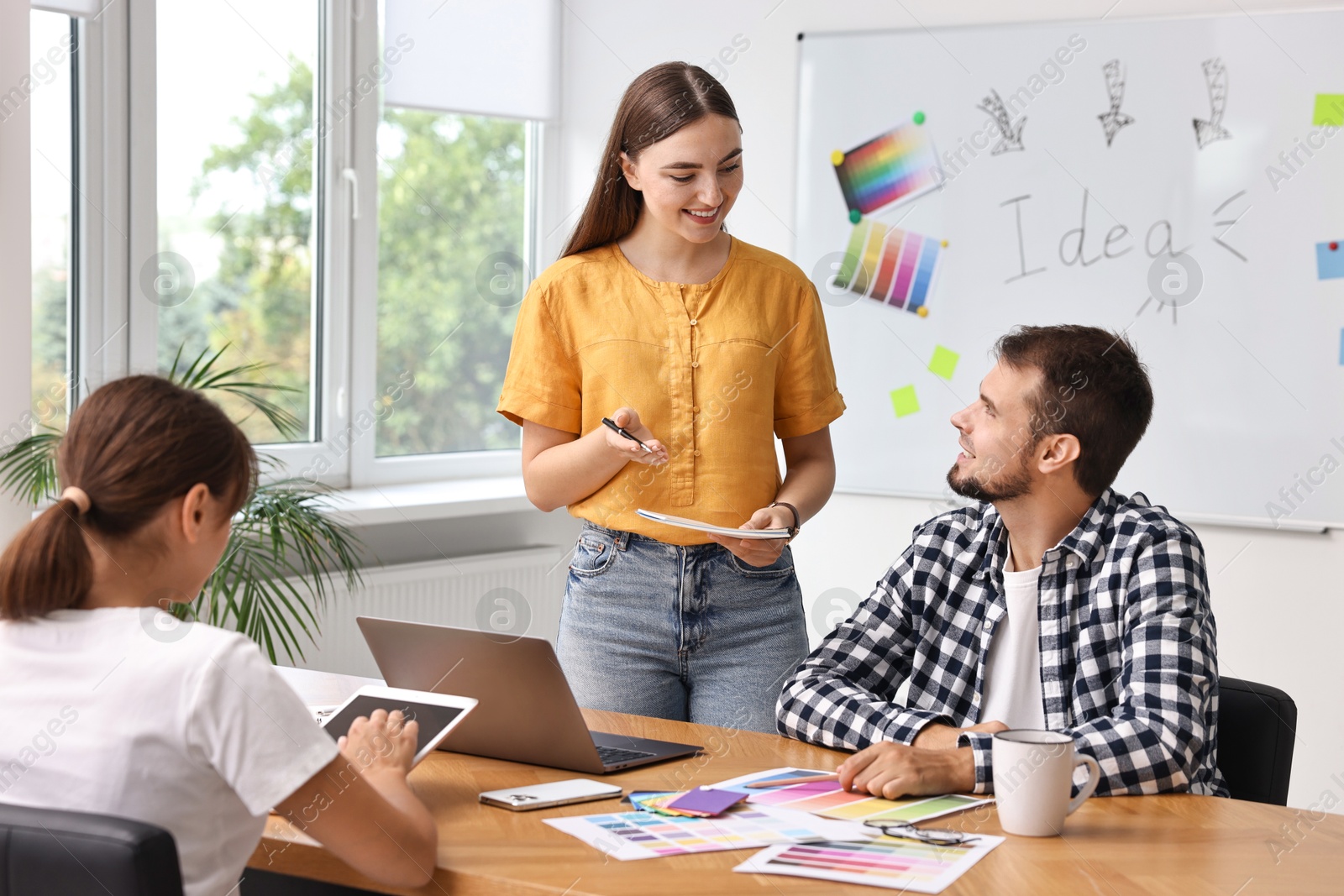 Photo of Group of designers working together in office