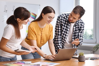 Photo of Group of designers working together in office