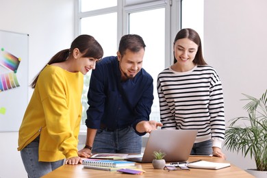 Photo of Group of designers working together in office