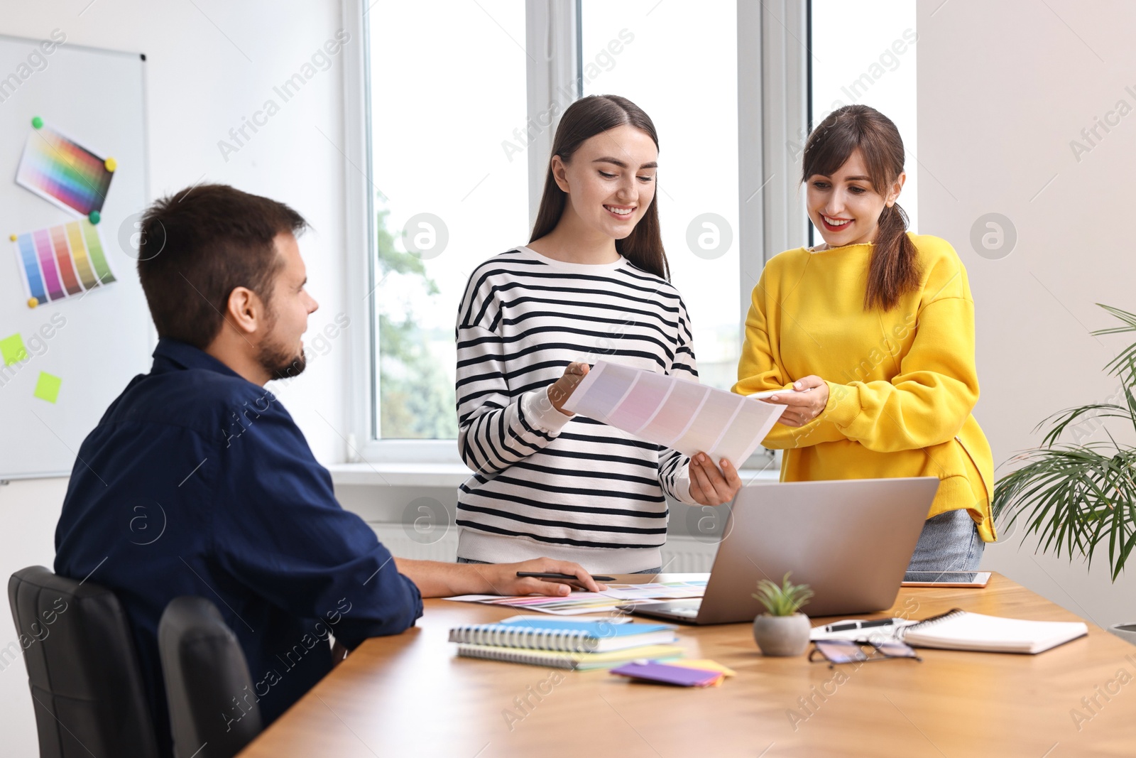 Photo of Group of designers working together in office