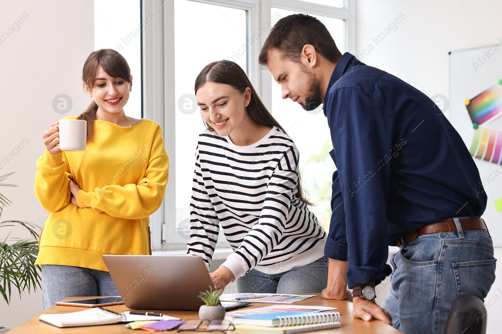 Photo of Group of designers working together in office