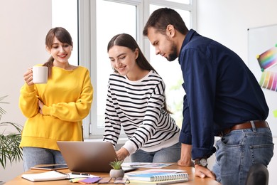 Photo of Group of designers working together in office