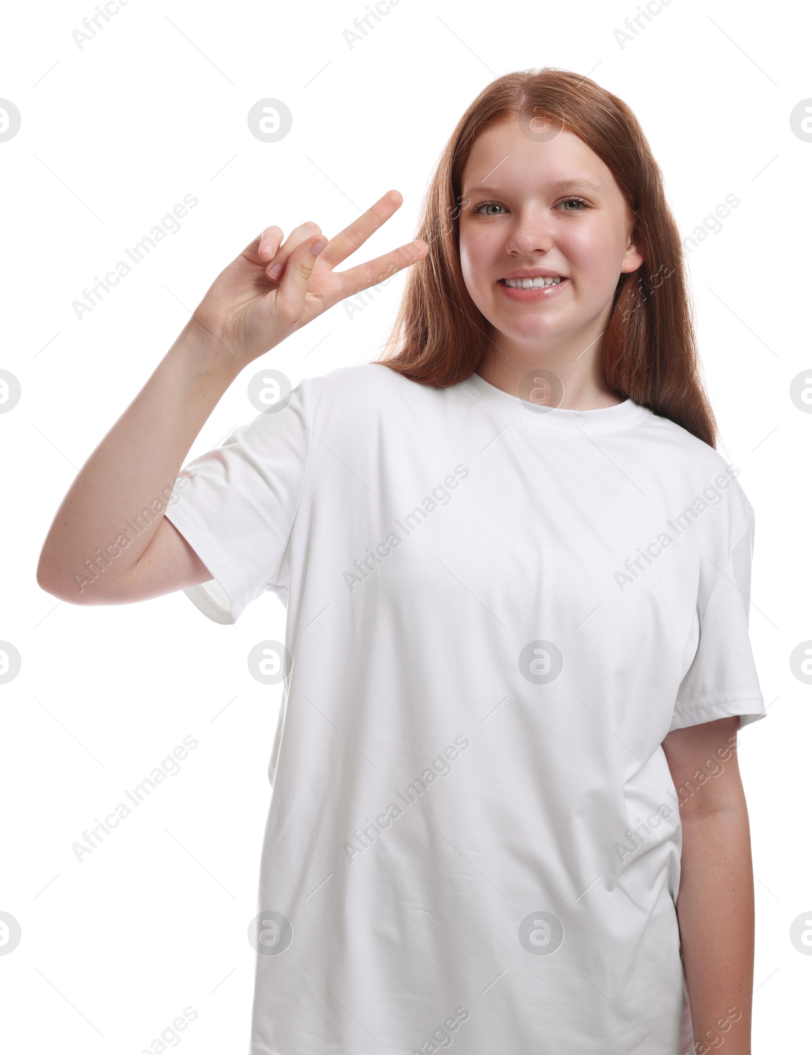 Photo of Teenage girl showing v-sign on white background