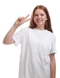 Photo of Teenage girl showing v-sign on white background